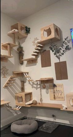 the cat tree is made out of wood and has several shelves on each side with various items hanging from them