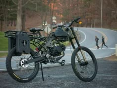 a motorcycle parked on the side of a road next to a man in black jacket