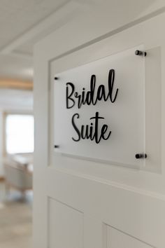 a sign that says bridal suite hanging on the side of a door in a room