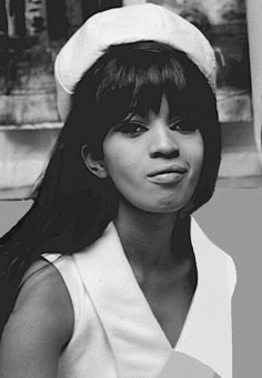 a black and white photo of a woman wearing a sailor's hat