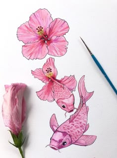 a pink flower and two fish on a white paper with watercolor pencils next to it