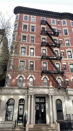 an apartment building with stairs leading up to it