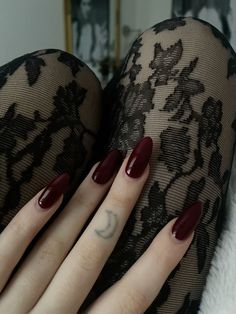 a woman's legs with red manicures and black lace stockings on them