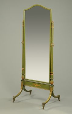 an antique mirror is sitting on a stand
