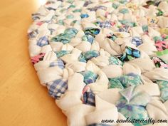 a wooden table topped with lots of fabric