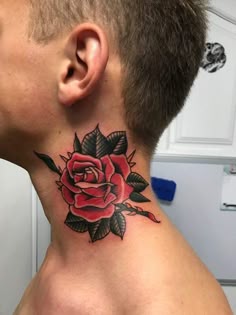 a man's neck with a rose tattoo on the top of his neck and bottom part