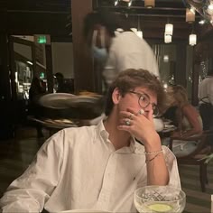 a man sitting at a table with food in front of him