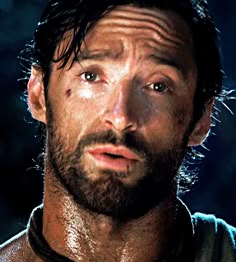 a close up of a man with wet hair and beards looking at the camera