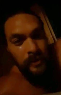 a close up of a man brushing his hair