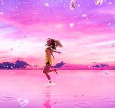 a girl is running in the water with her hair blowing in the wind and flying around