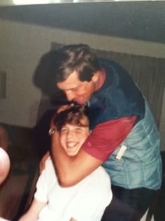 two men are hugging each other and smiling