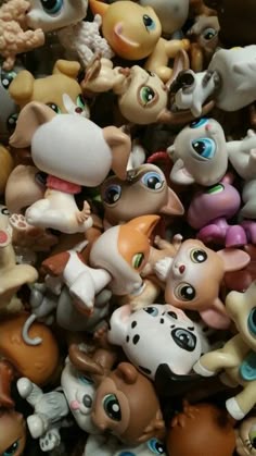 there are many small toy animals together in this pile, all different colors and sizes