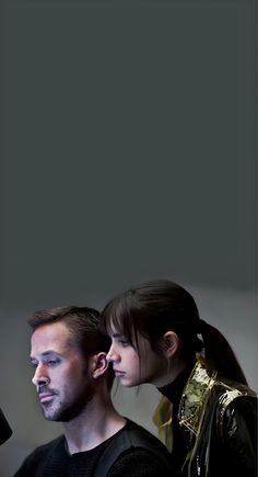 a man and woman are staring at something