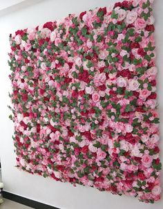 a large flowered wall hanging on the side of a building