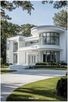a large white house sitting on top of a lush green field