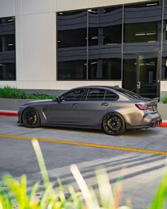 a silver car parked in front of a building