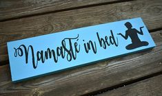 a wooden sign that says namasthe in bed