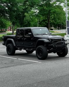 a black jeep parked in a parking lot