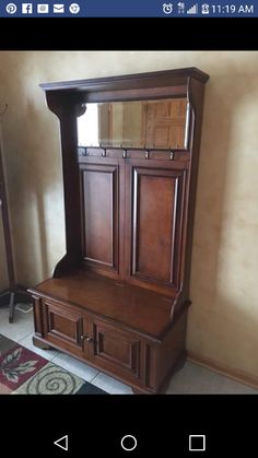 a large wooden cabinet sitting in the corner of a room