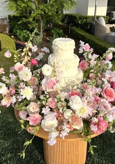 a wedding cake sitting on top of a flower pot
