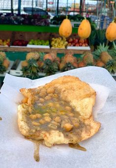 a piece of food sitting on top of a white napkin next to other fruits and vegetables