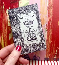 a person holding up a book in their hand