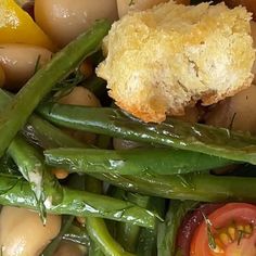 green beans, tomatoes, and other vegetables are piled up on top of each other