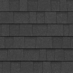 a black shingled roof with white dots on the top and bottom tiles in grey