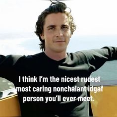 a man sitting on top of a boat next to the ocean with his arms crossed