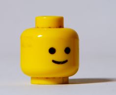 there is a yellow lego with a smiley face on it