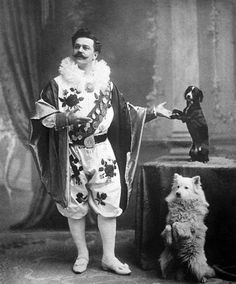 an old black and white photo of a man standing next to a dog