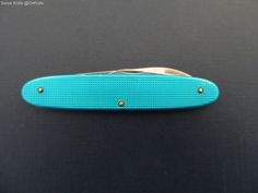 a blue knife sitting on top of a table