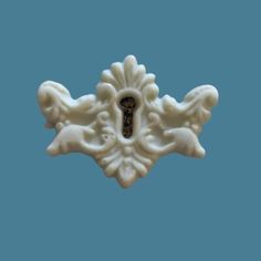 a white decorative object on a blue background