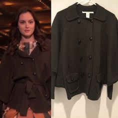 a woman standing next to a black jacket