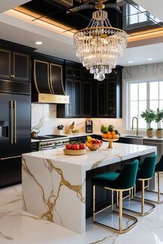 a kitchen with black cabinets and white marble counter tops, gold trimming on the island