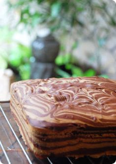 a chocolate cake sitting on top of a metal rack