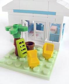a small toy house with furniture in front of it