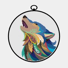 a cross - stitch ornament with a wolf's head in the center