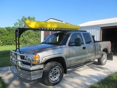 a pick up truck with a kayak on the roof