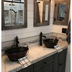 two sinks in a bathroom with mirrors above them