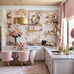 a kitchen with pink chairs, gold accents and artwork on the wall behind the counter