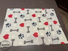 a dog paw and bone print blanket on a counter