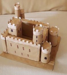 a castle made out of cardboard sitting on top of a bed