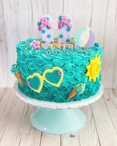 a birthday cake with blue frosting and decorations