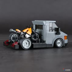 a lego motorcycle is parked on the back of a truck