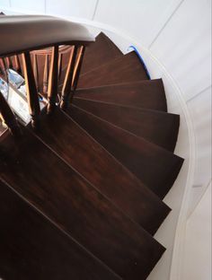 an overhead view of a wooden staircase with handrails