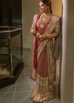 a woman in a red and gold sari