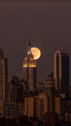 the full moon is seen over new york city