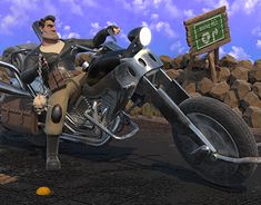 a man riding on the back of a motorcycle next to a pile of rocks and a sign