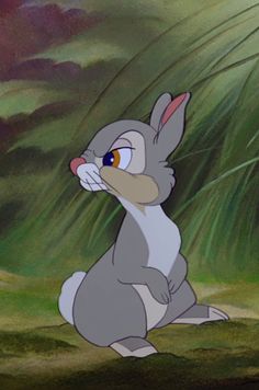 an animated rabbit is sitting in the grass